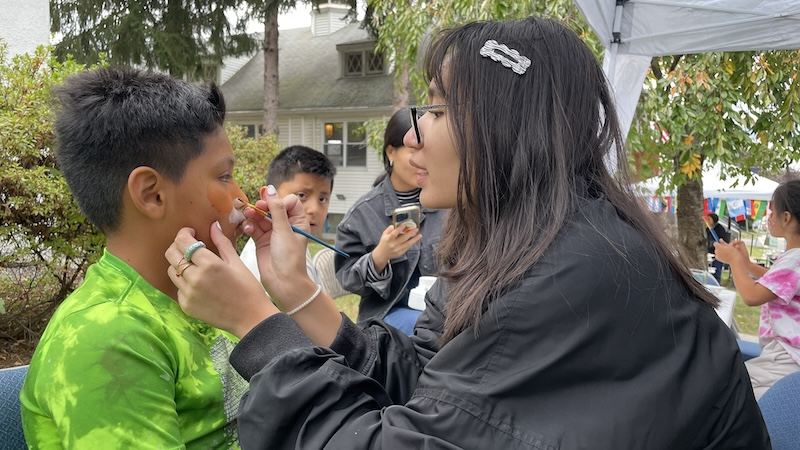 Child receiving face painting at a church gathering